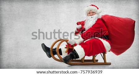 Santa Claus on his sledge with a bag full of Christmas gifts