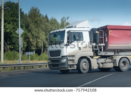 a trailer truck turns on an asphalt road.