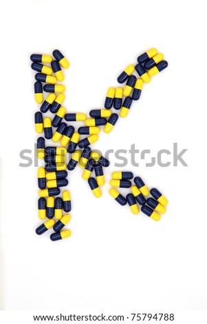 The letter K alphabet made of medical capsules