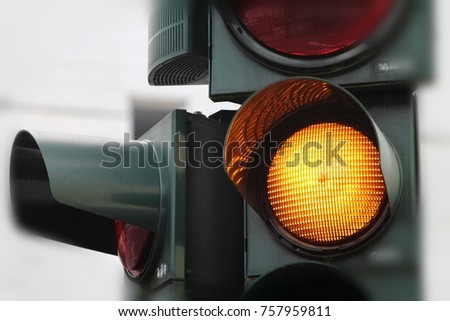 Yellow traffic light close up. German street. Mist wearther.