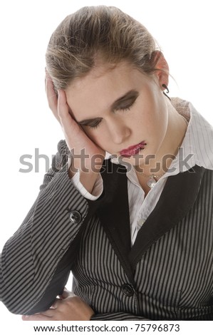 Young businesswoman with lip piercing in a gray business suit and high heels young woman touches his head and has a headache, isolated on a white background