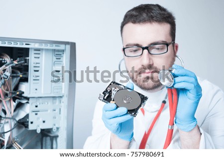 Lab engineer repairing and fixing broken hard disk for data recovery
