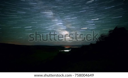 Blurred milky way over rural oregon with black and earth rotation from space