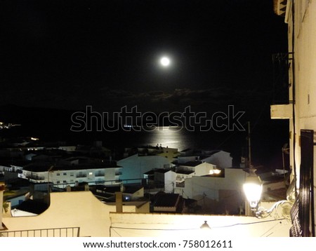 Moon at night in mediterranean town