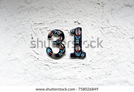 Ceramic numbers on the white wall