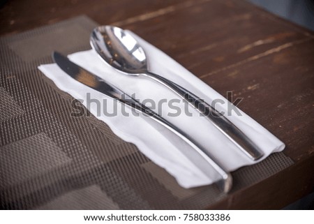 
Stack and knife on wooden table