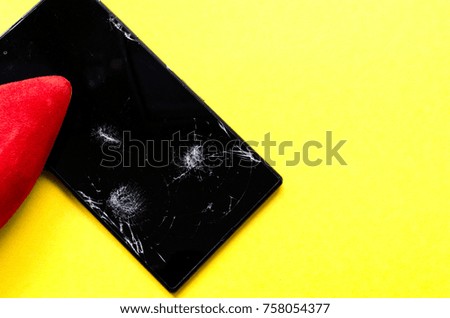 
the foot in the red  shoe comes on the phone on yellow background