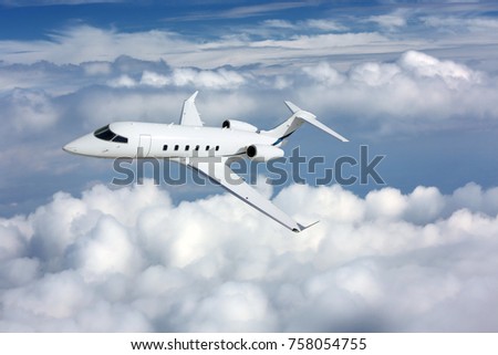 Business jet airplane flying on a high altitude above the clouds Royalty-Free Stock Photo #758054755