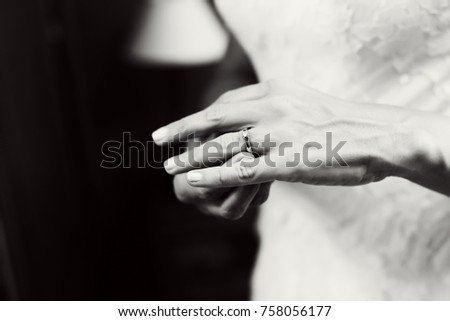 Bride wearing her engagement ring. Wedding. Black and white. Close up picture. Unrecognizable person. 