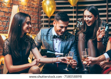 Party celebration. Friends pouring champagne and having fun. New year, Birthday, Holiday Event concept