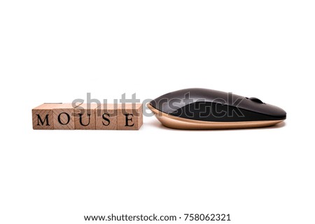 Black Golden wireless mouse on Wooden Blocked written MOUSE on white isolated background
