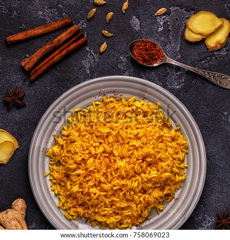 Saffron rice with spices. Top view, copy space. Royalty-Free Stock Photo #758069023