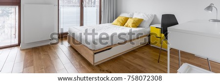 White, multifunctional bedroom with desk and double bed, panorama