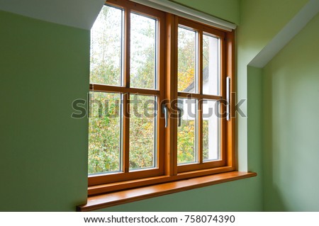 Double glazed wooden window frame in the home in the autumn Royalty-Free Stock Photo #758074390