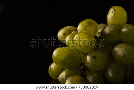 Green grapes on dark background