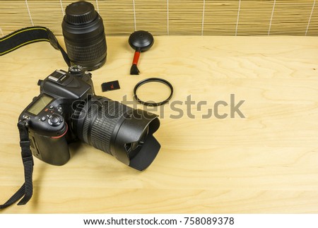 Camera and equipment on a wooden desk.