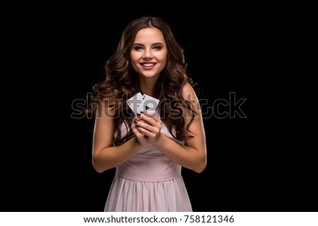 Attractive young woman holding the winning combination of poker cards
