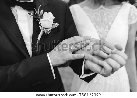 Together, the bridegroom and the bride are always holding their hands. Black and white picture.
