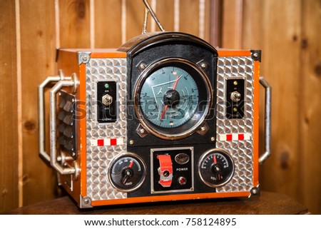 Vintage radio at the wooden wall background