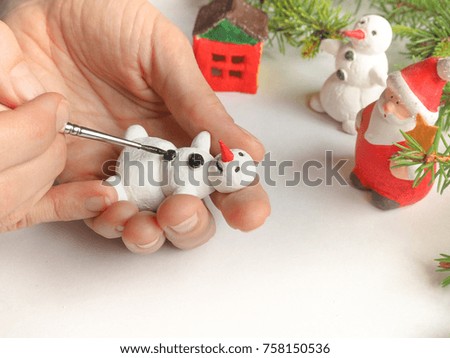 Handmade manufacture of a small toy snowman. Preparations for the celebration of Christmas.