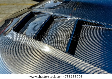 Kevlar carbon fiber texture on a car hood. Various vehicle details in Southern California.