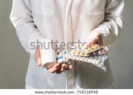 Woman holding stack of pills. Close up. front view. Health care concept. Royalty-Free Stock Photo #758158948