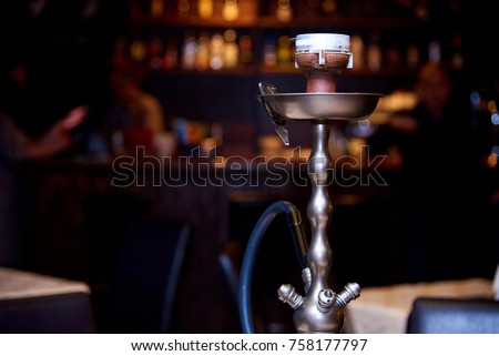 Hookah on a dark background of a blurry bar with a bokeh.Copy space Royalty-Free Stock Photo #758177797