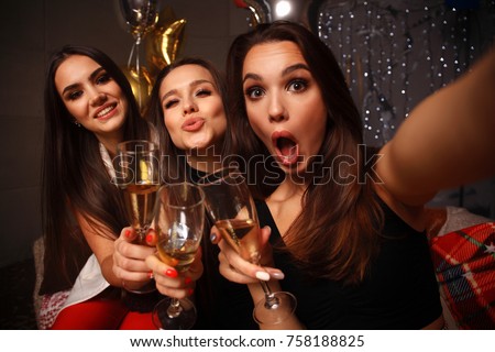 Beautiful girls having party fun, drinking champagne. Holidays, celebration, nightlife and people concept - smiling friends dancing in club