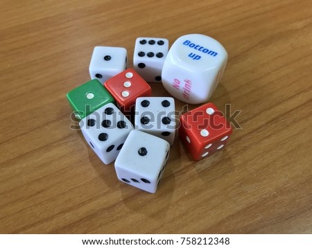 Probability learning using dices, white dices on wooden table for gaming, multidimensional cubes