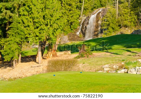 Golf place with gorgeous green over fantastic waterfall view