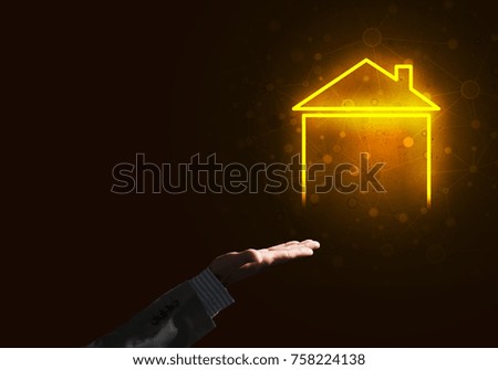 Businessman hand presenting glowing home icon or symbol
