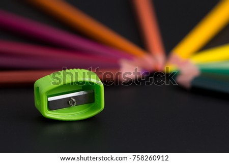 Pencils and Sharpener On Black Background Close-up