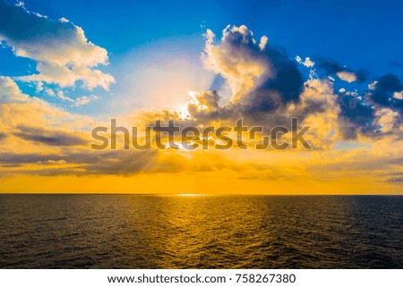 Panoramic dramatic sunset sky and tropical sea at dusk. Beautiful colorful photo.