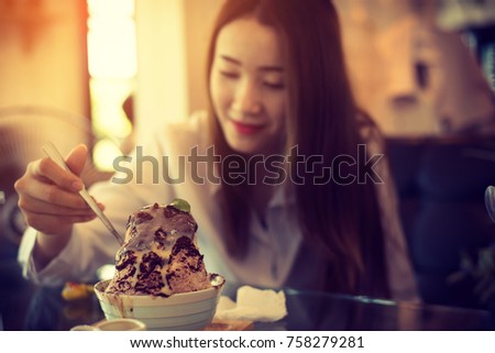 woman eating a icecream desert, vintage color tone