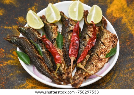 Caribbean Sardine or pilchard fry fish curry with salad tasty sea food cuisine, Kerala India. Popular dish in coastal area restaurants Singapore, Thailand.