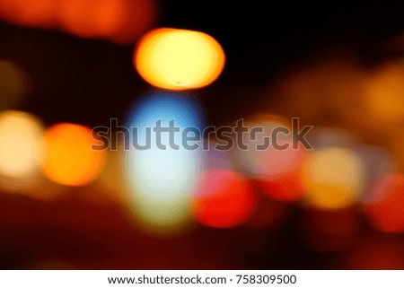 Road at night with traffic trails and blurred lights