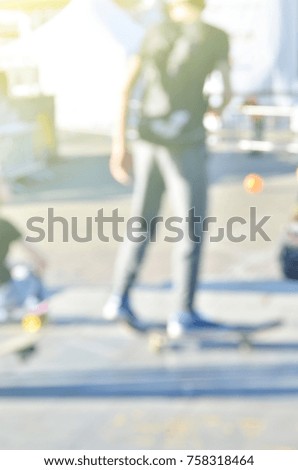 Defocused and blurred image for background of young people  skating on skateboard.
