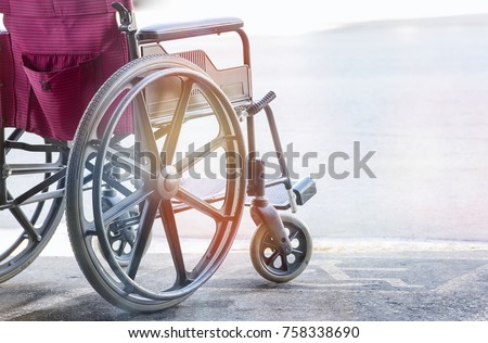 close up view of empty wheelchair with Pavement handicap symbol  Royalty-Free Stock Photo #758338690