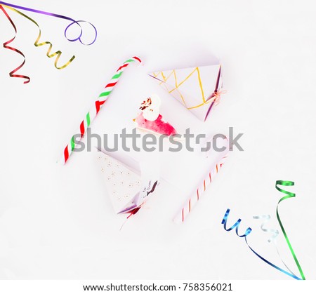 Flat Lay Style Christmas Decoration with cake slice gift boxes with cake piece and candy canes and confetti bursting for best background image for Holiday invitations and banners and blogs