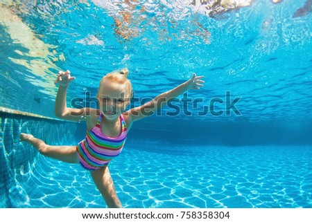 Funny portrait of child learn swimming, diving in blue pool with fun - jumping deep down underwater with splashes. Healthy family lifestyle, kids water sports activity, swimming lesson with parents. Royalty-Free Stock Photo #758358304