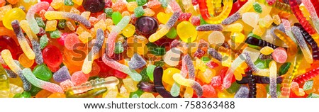 panorama close up a background from colorful sweets of sugar candies and marmalade. assortment candies panoramic view 