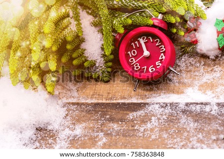 Merry Christmas and Happy New Year, winter season. Midnight clock on wood background.