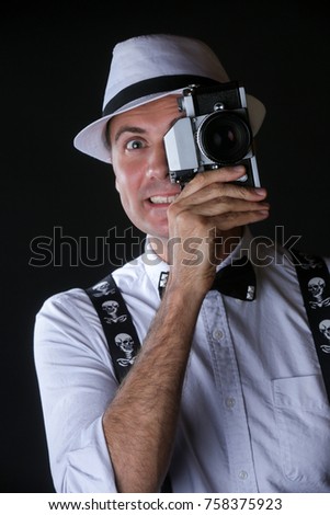 Young stylish man with photo camera