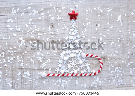 Christmas tree made of snowflakes on a light wooden background. Christmas, winter, new year concept. Top view.