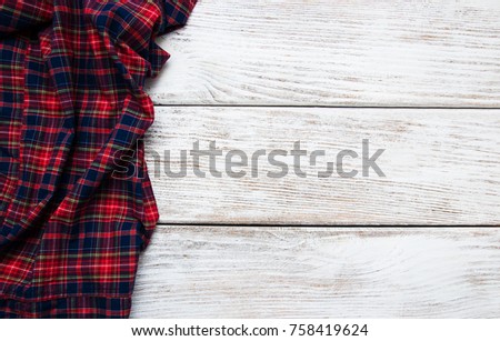 Checkered napkin on a old wooden  background