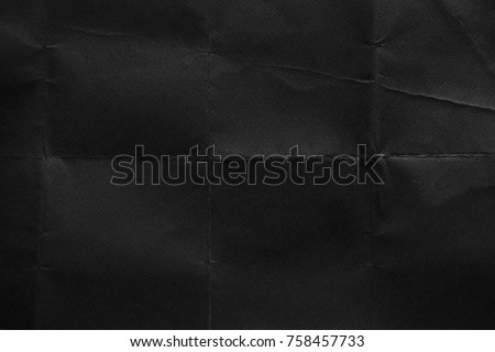 Old black paper texture. Grunge background. Fold. Crumpled texture