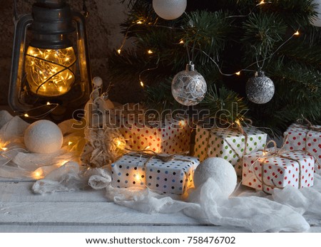 Christmas and new year holiday celebration concept background. Lighted candles, xmas tree decoration, gifts on wooden table.