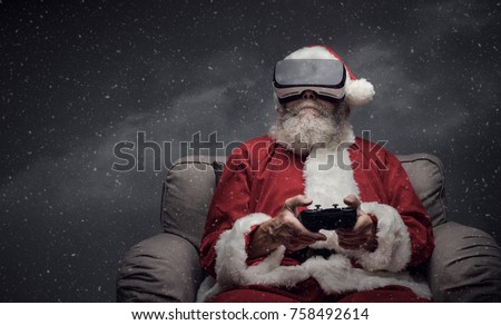 Santa Claus experiencing virtual reality at home and playing videogames using a controller, he is wearing a VR headset and he is surrounded by snow