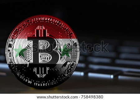 Bitcoin close-up on keyboard background, the flag of Syria is shown on bitcoin.