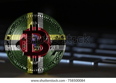 Bitcoin close-up on keyboard background, the flag of Dominica is shown on bitcoin.